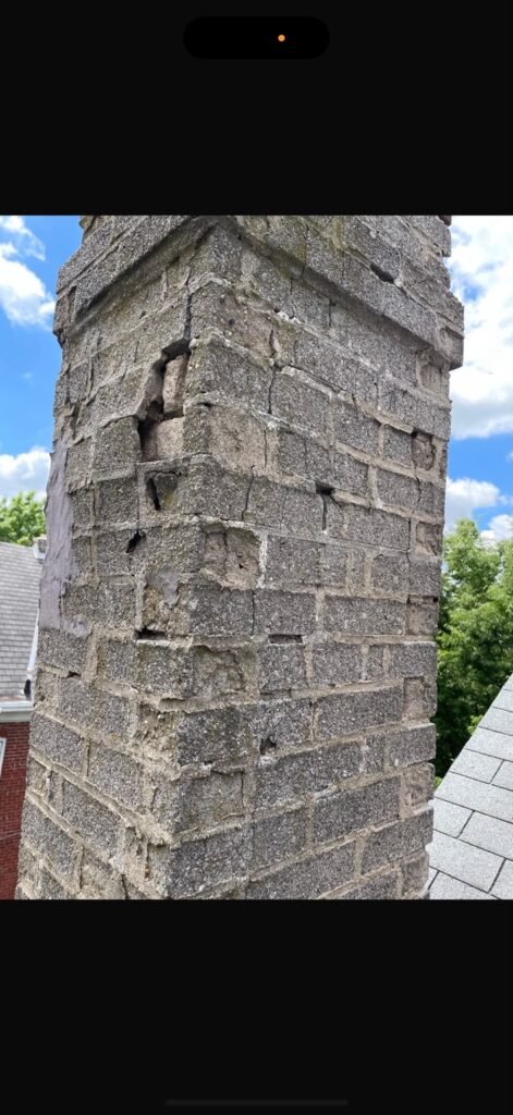 Metal flue pipe extending from the original brick chimney
