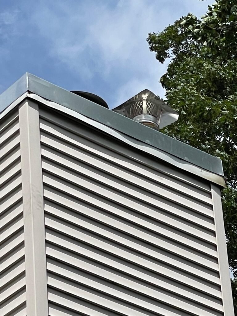 Chimney chase top with new metal cap and chimney cap installed