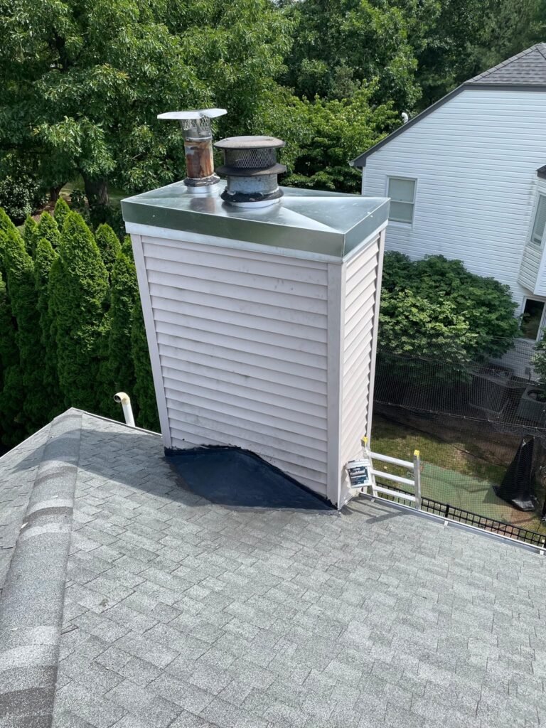 Chimney chase base and roof interface with flashing repair