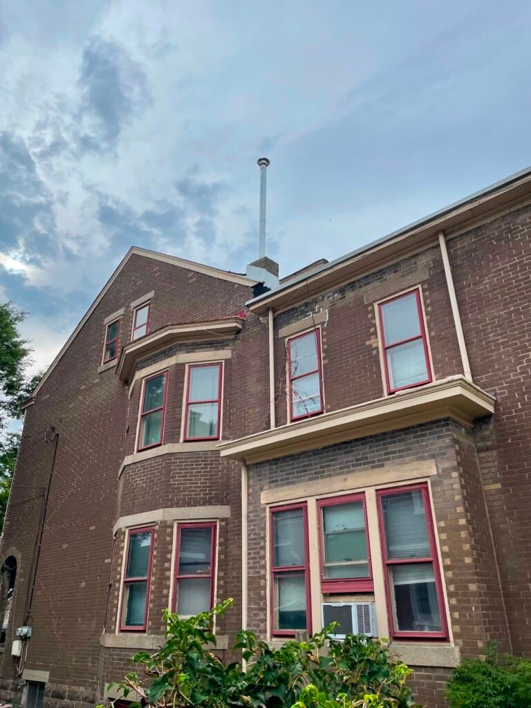 Metal chimney liner termination at the top of the original brick chimney