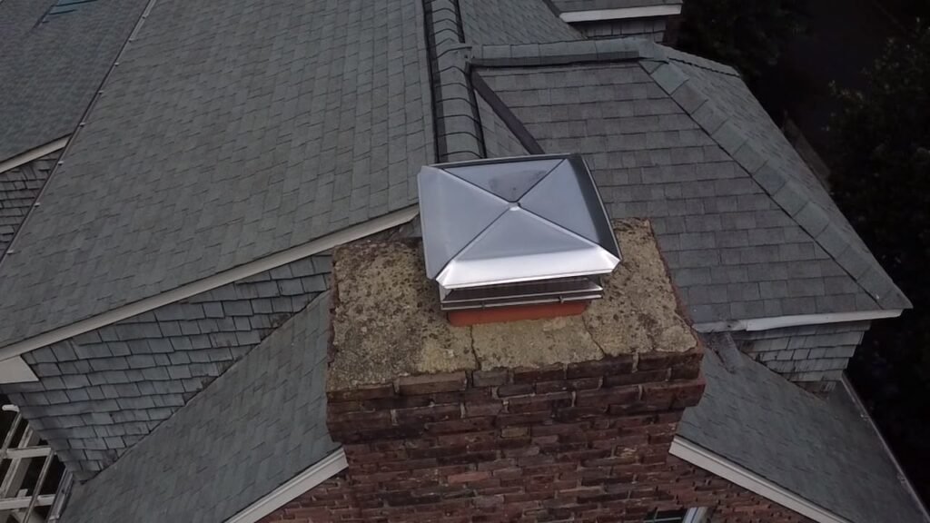 Chimney crown and single cap viewed from the roofline