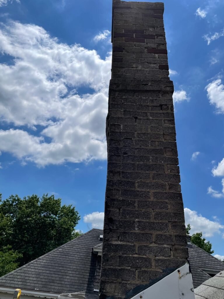 Close-up of deteriorated brick and missing mortar on the original chimney